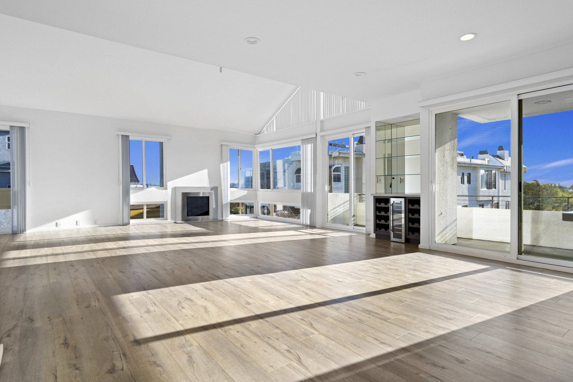 Alternate interior view of empty living room with large vertical windows