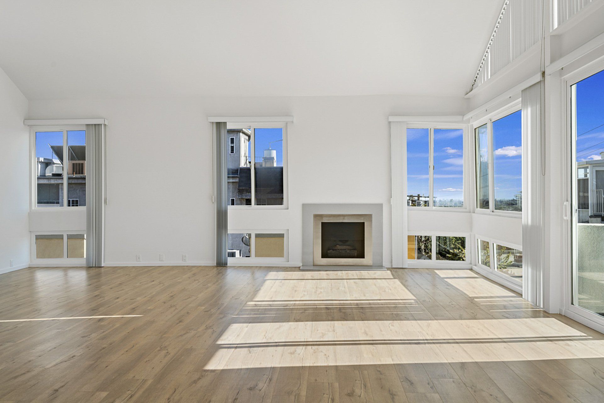 Interior view of fireplace and windows overlooking cityscape