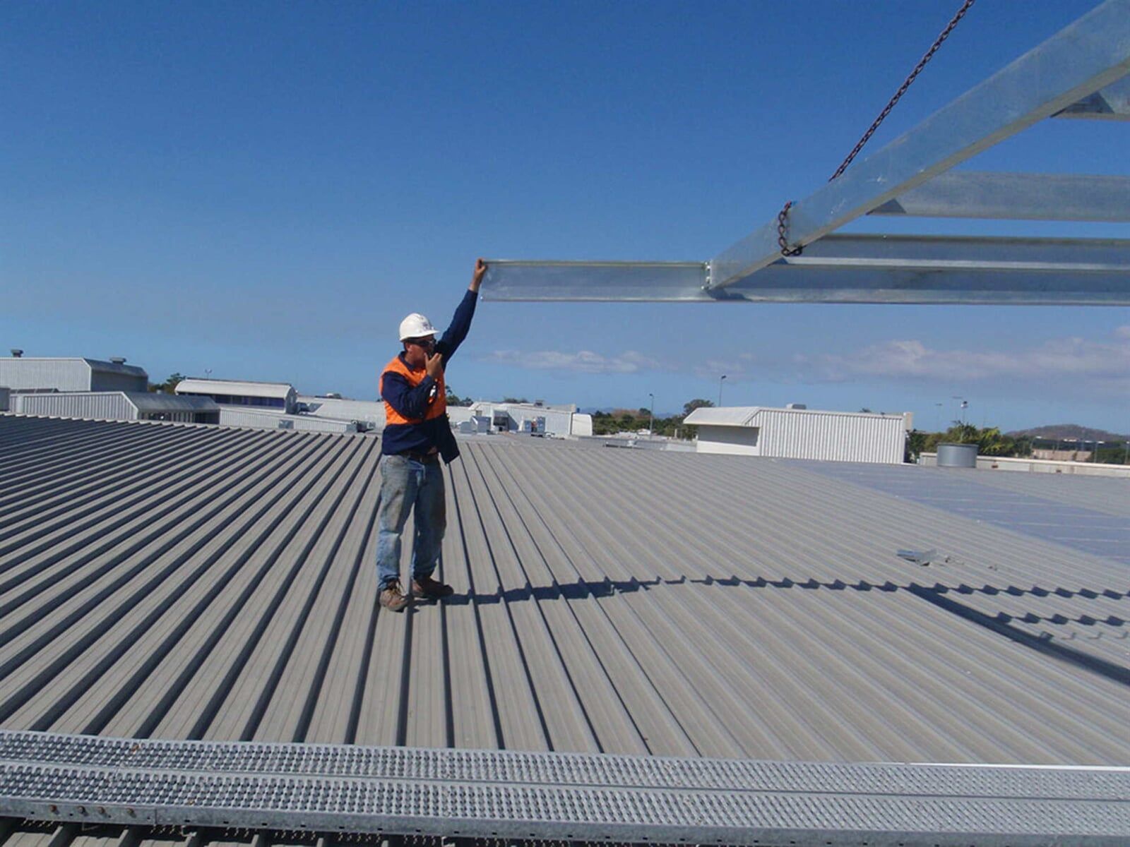 Man Guiding Metal Bar - Crane Hire in Townsville, QLD