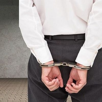 Young businessman wearing handcuffs - criminal defense lawyer, criminal defense attorney in Ocala, FL Young businessman wearing handcuffs - criminal defense lawyer, criminal defense attorney in Ocala, FL