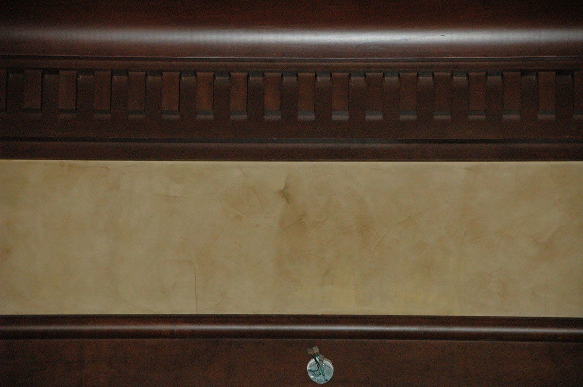 A close up of a wooden dresser with a lock on it