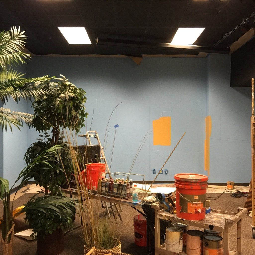 A bucket of paint sits on a table in a room