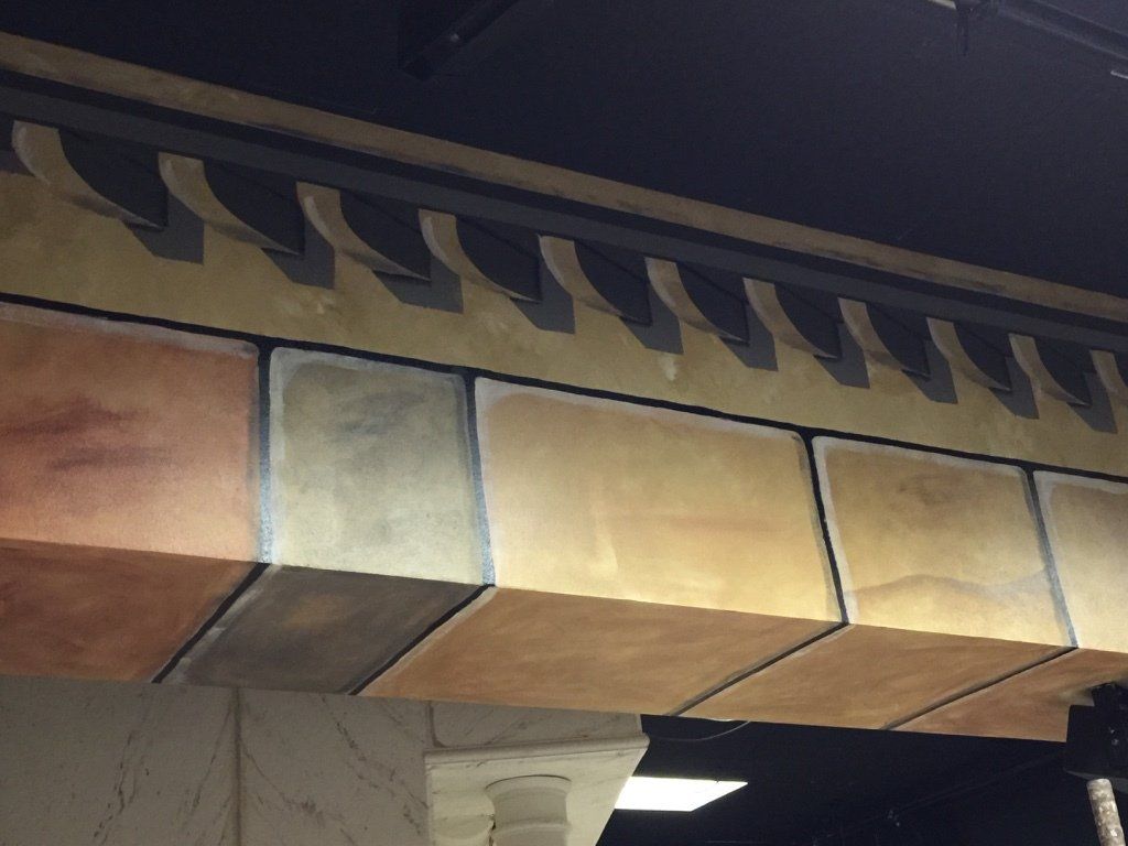 A ceiling with a row of bricks on it