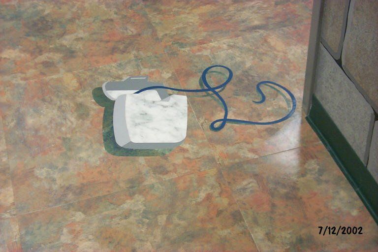 A picture of a telephone on the floor was taken on 7/12/2002