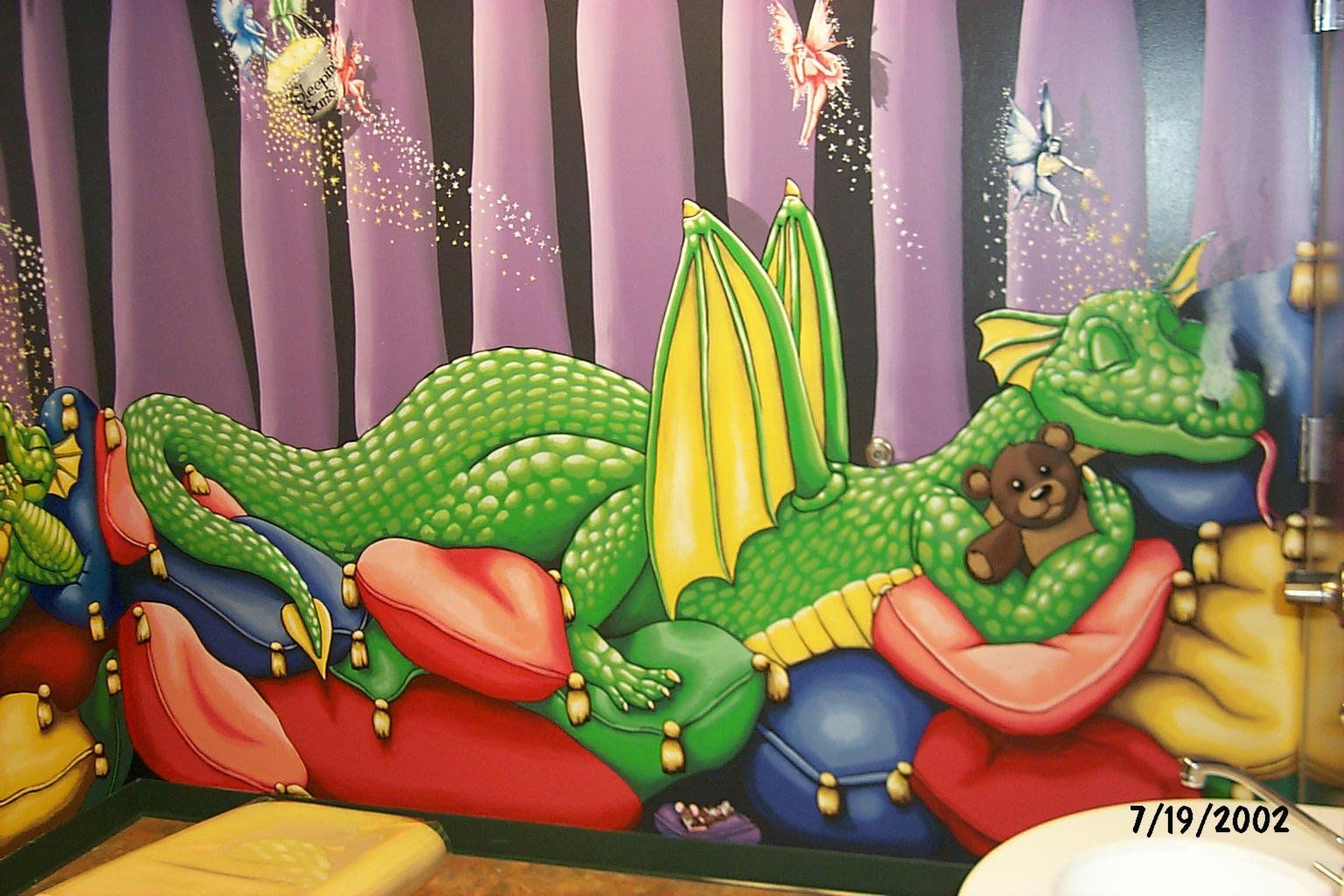 A painting of a dragon laying on a bed with a teddy bear