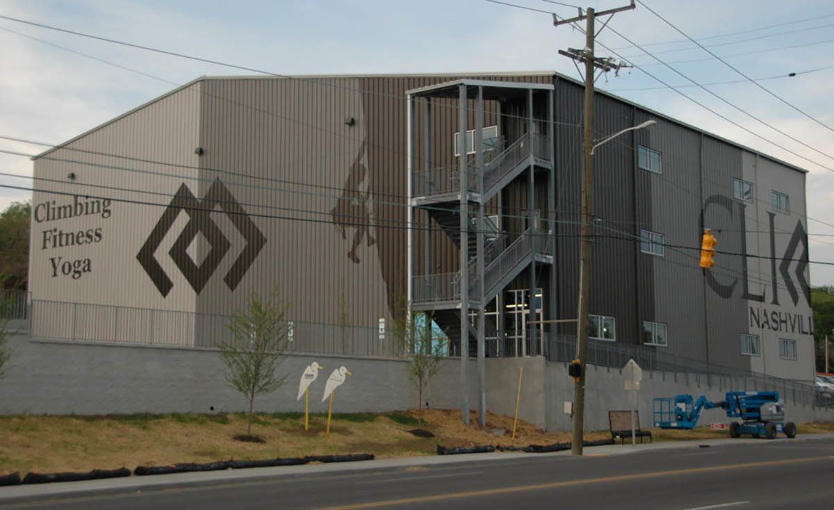 A large building that says climbing fitness yoga on it