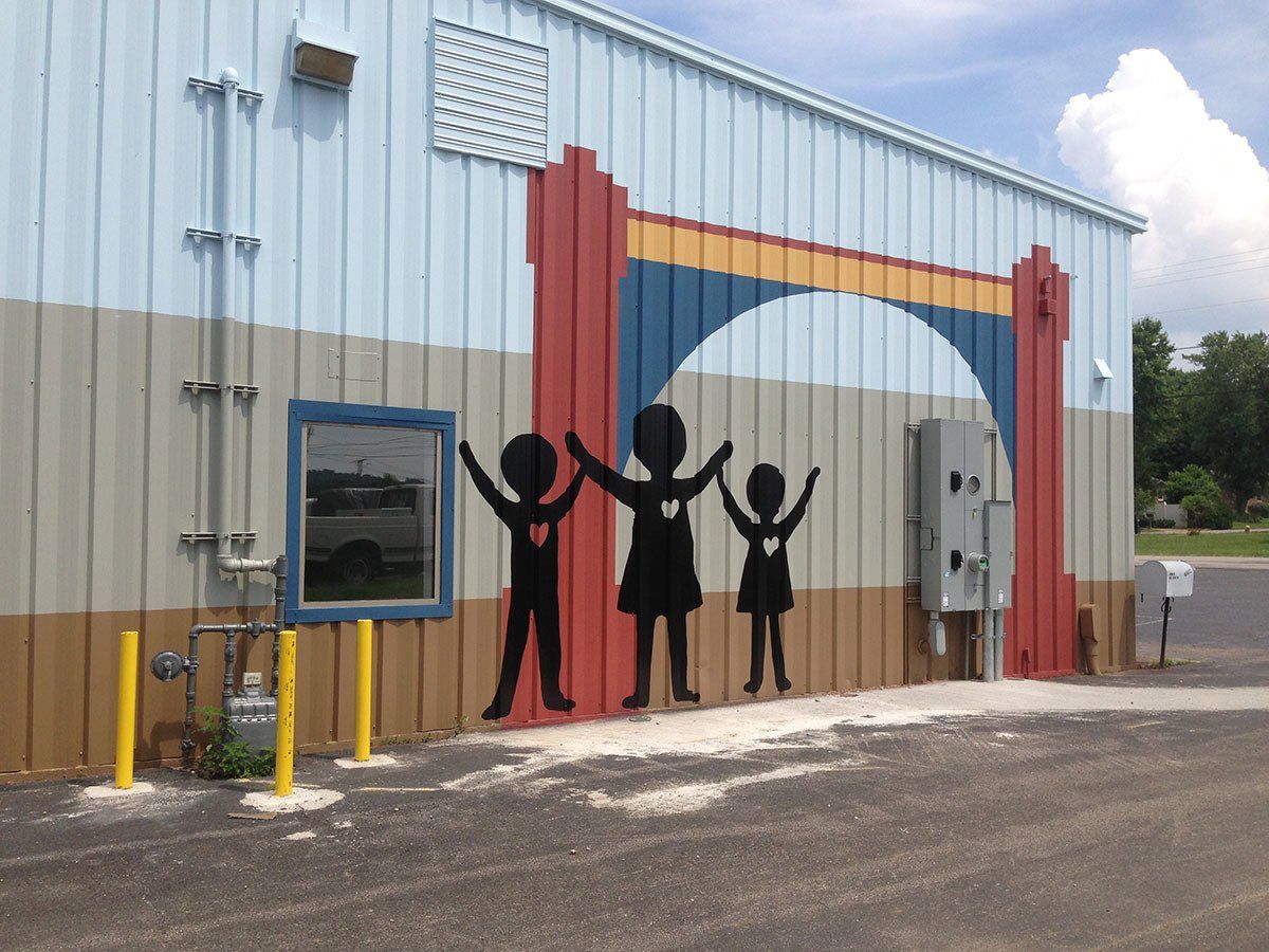 A building with a painting of a family holding hands