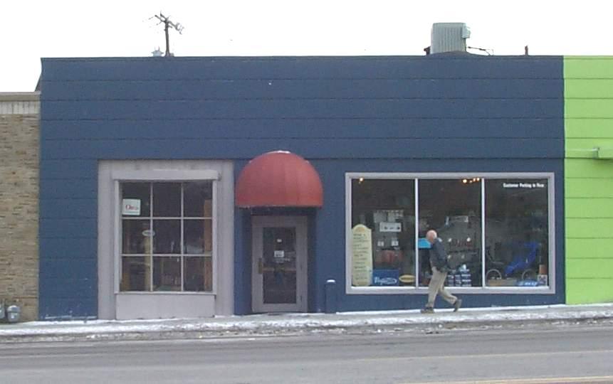 A blue building with a red awning on it