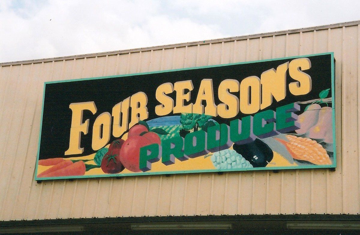 A sign that says four seasons produce on it