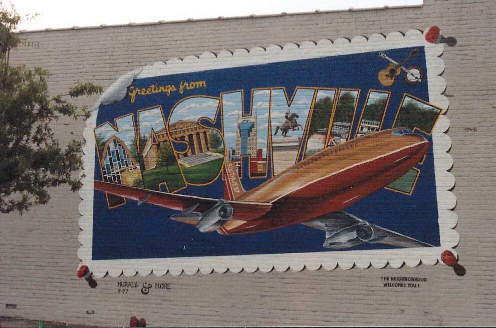 A mural on the side of a building that says greetings from nicholas
