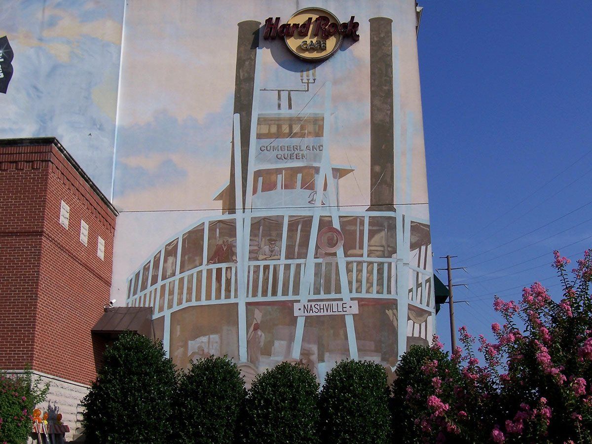 A mural on the side of a building that says hard rock
