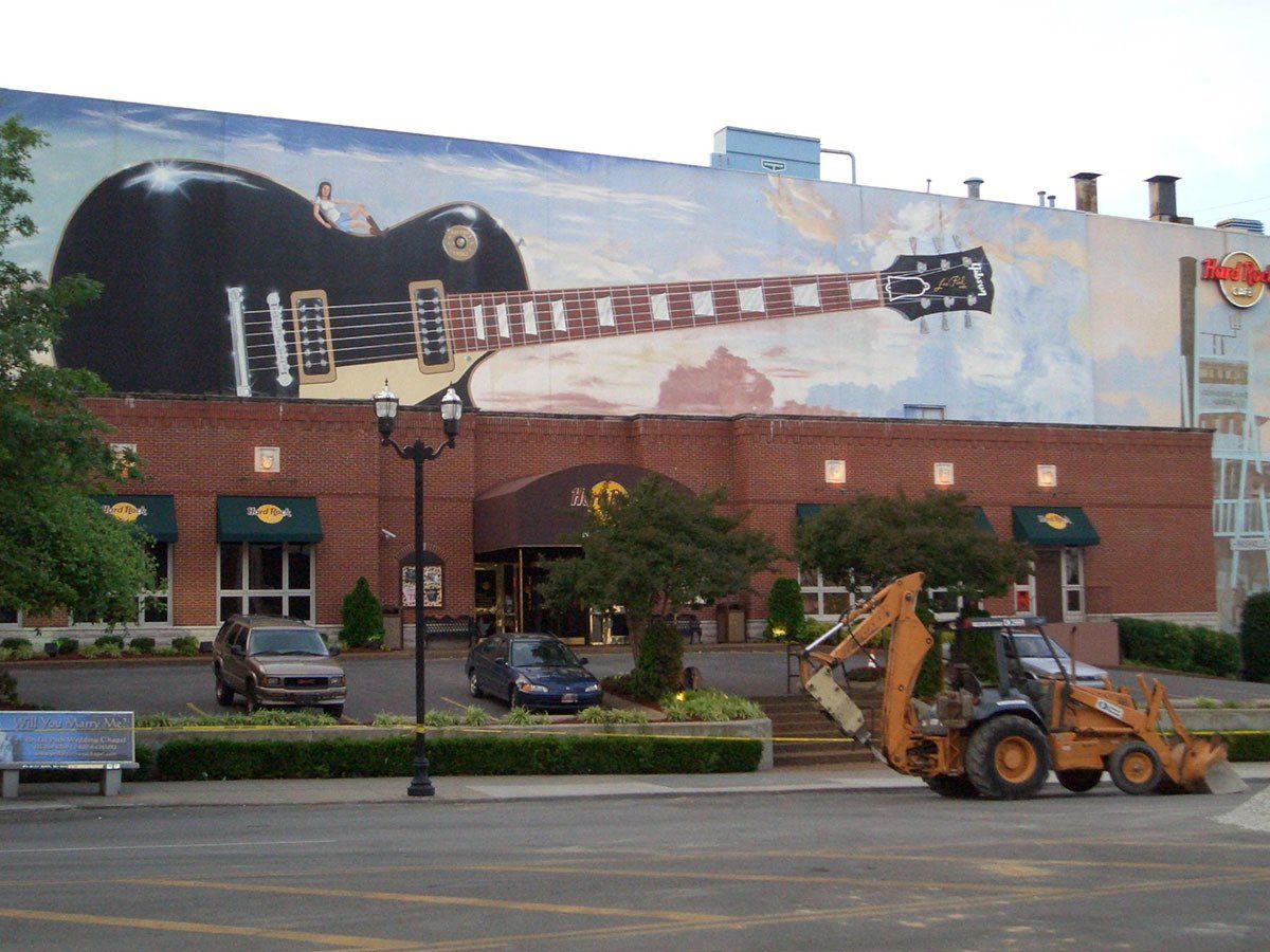 A large guitar is painted on the side of a building