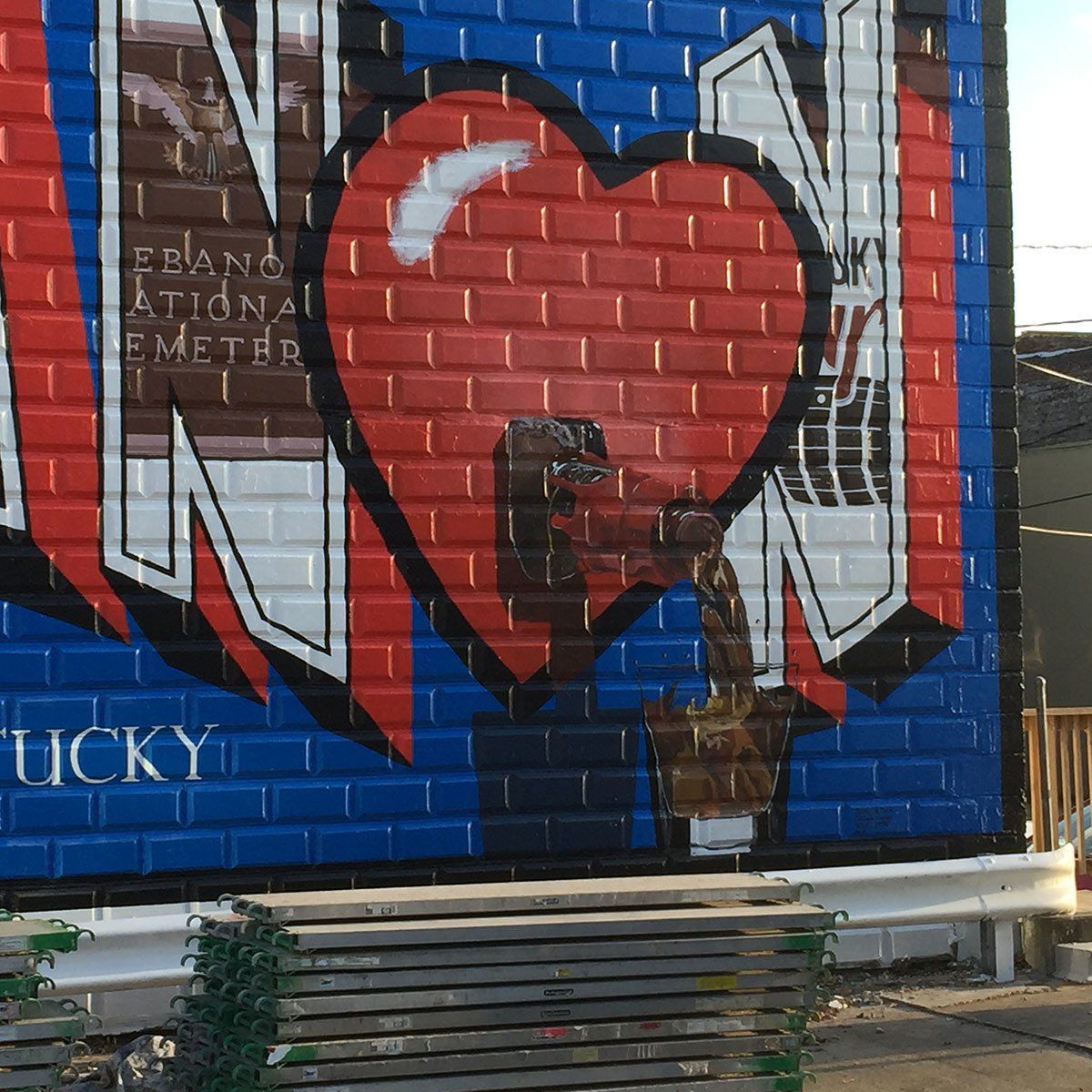 A brick wall with graffiti on it that says tucky