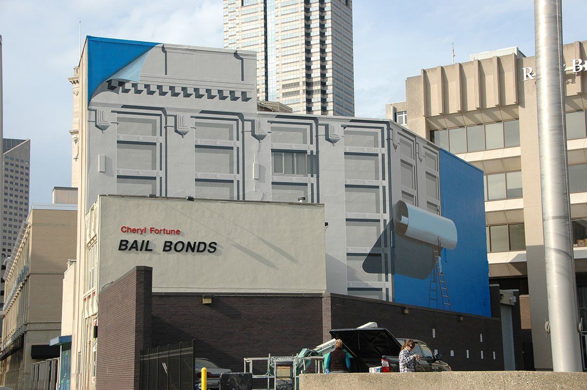 A large billboard on the side of a building that says bail bonds