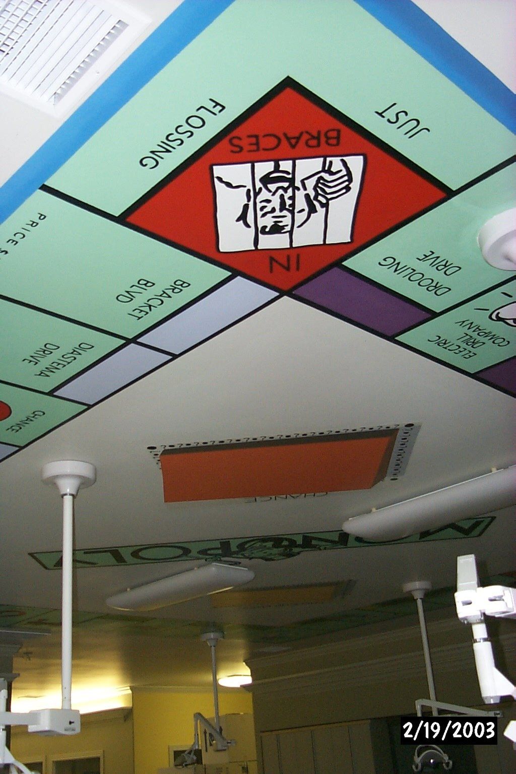 A monopoly board that says flossing and braces on it
