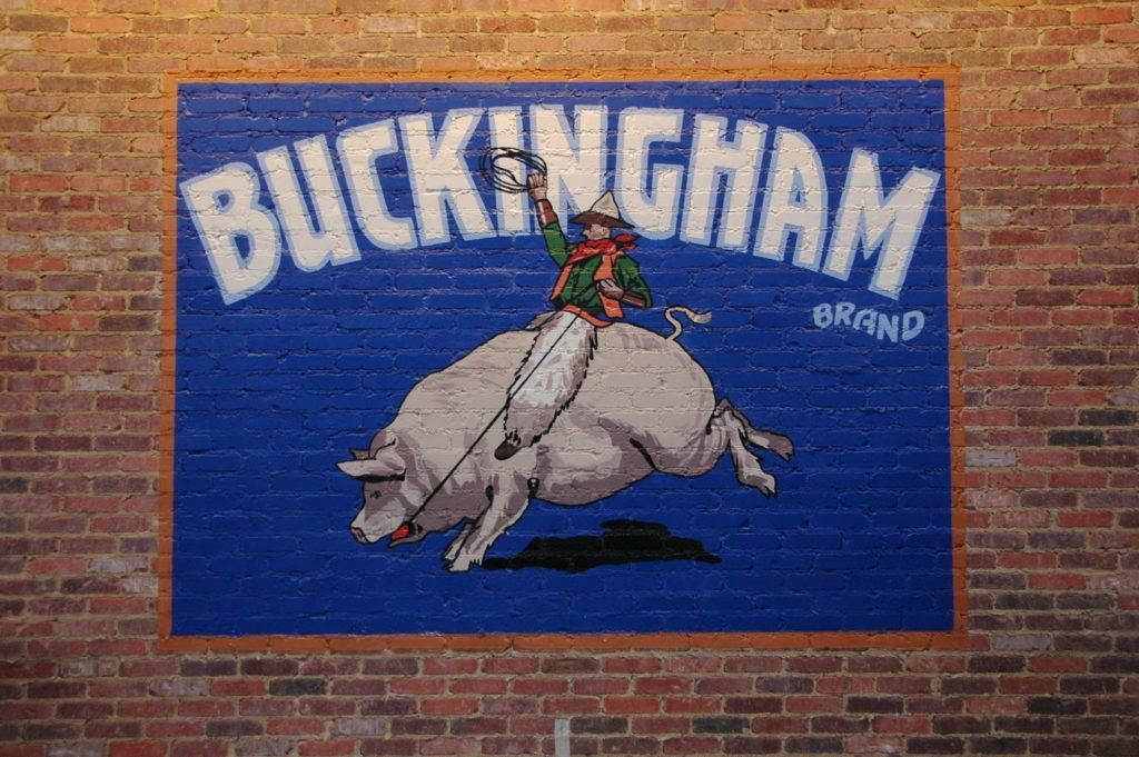 A brick wall with a buckingham brand sign on it