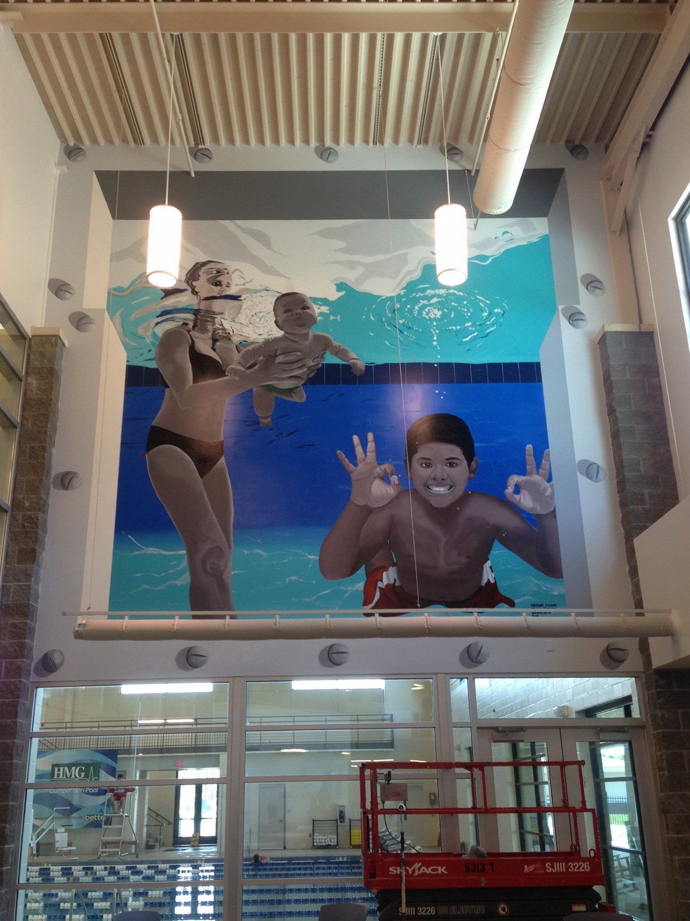 A large mural of a man and woman swimming in a pool