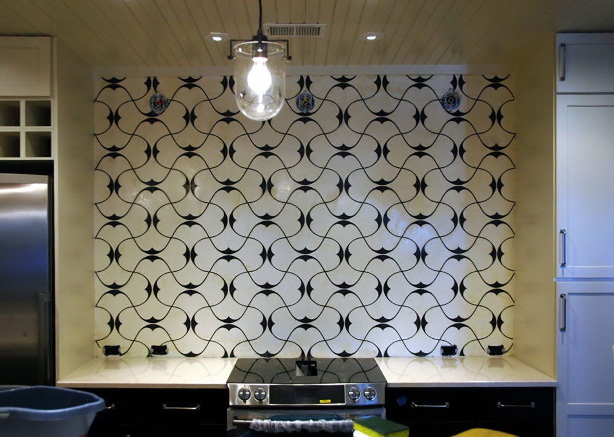 A kitchen with a stove top oven and a ceiling light