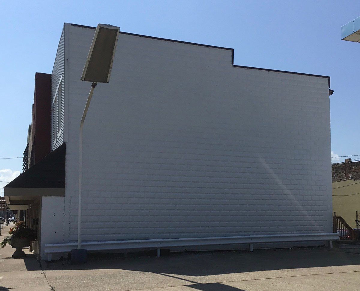 A large white building with a sign on the side of it