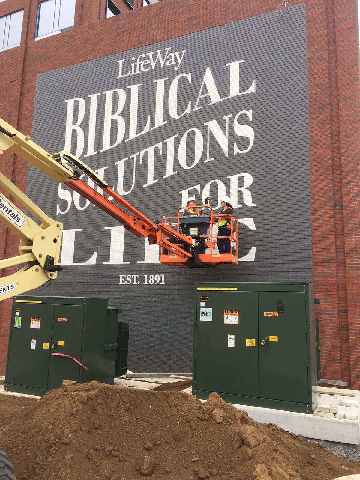 A large sign on the side of a building that says biblical solutions for life