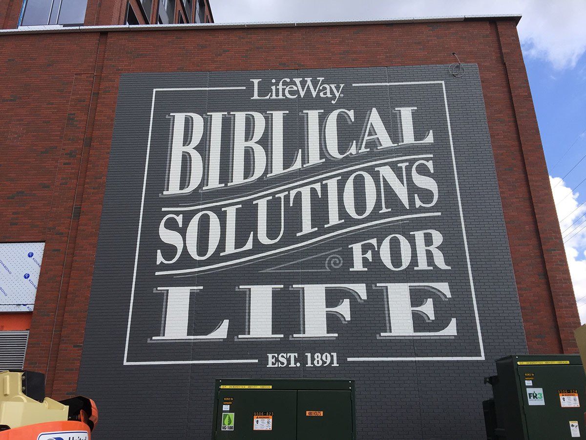 A large sign on the side of a building that says biblical solutions for life