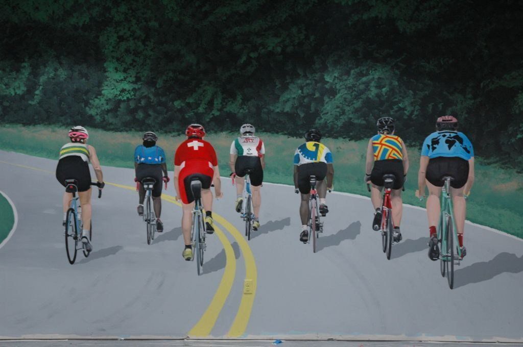 A painting of people riding bicycles down a road