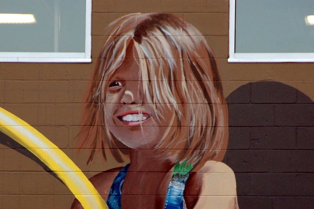 A painting of a young girl holding a yellow hula hoop