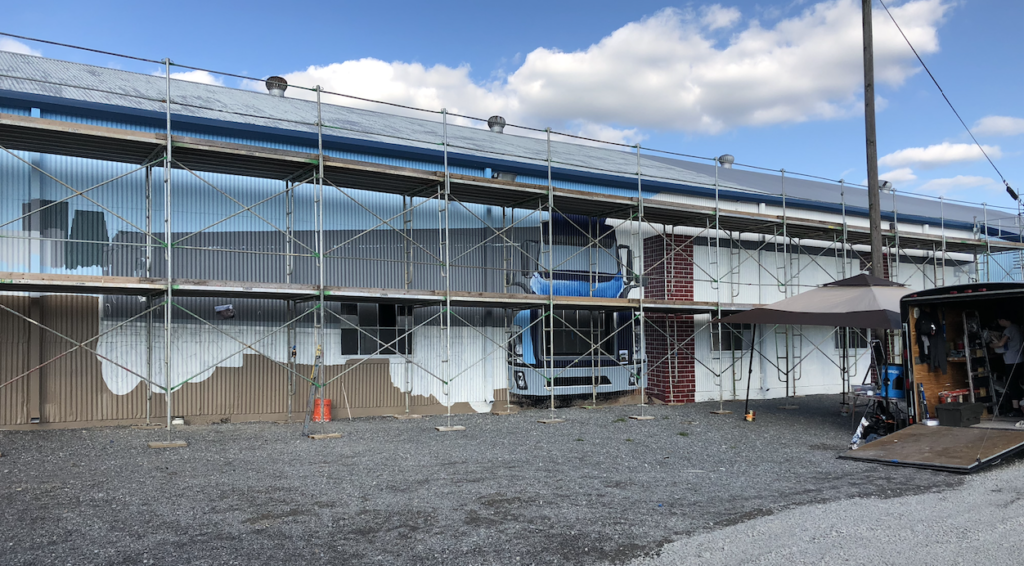 A large building is being remodeled with scaffolding around it.