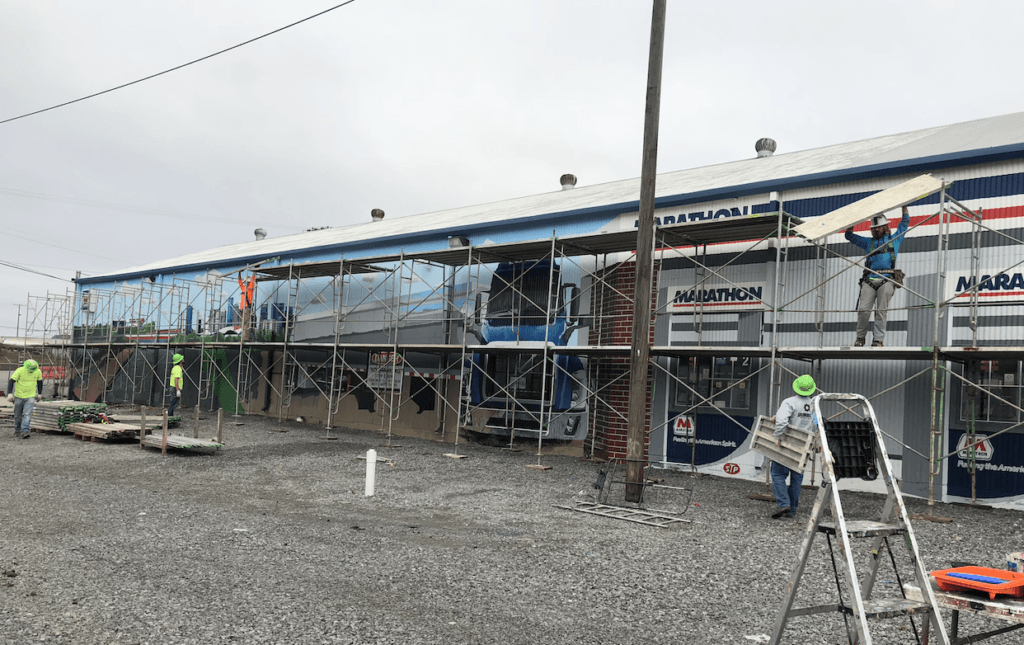 A group of construction workers are working on a building.