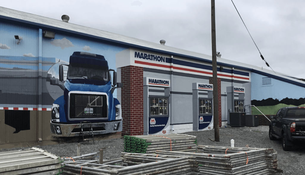 A truck is painted on the side of a building