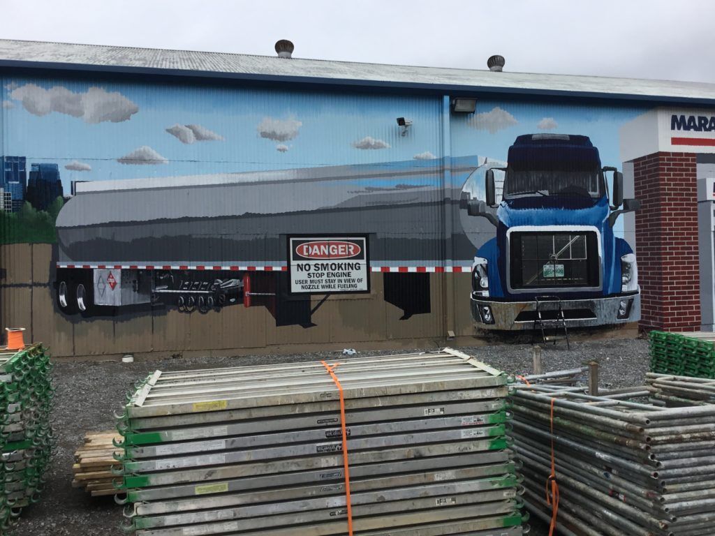 A truck is painted on the side of a building