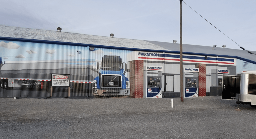 A truck is painted on the side of a building