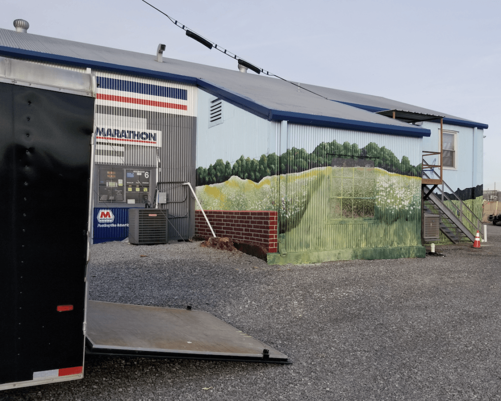 A trailer is parked in front of a building that says aviation