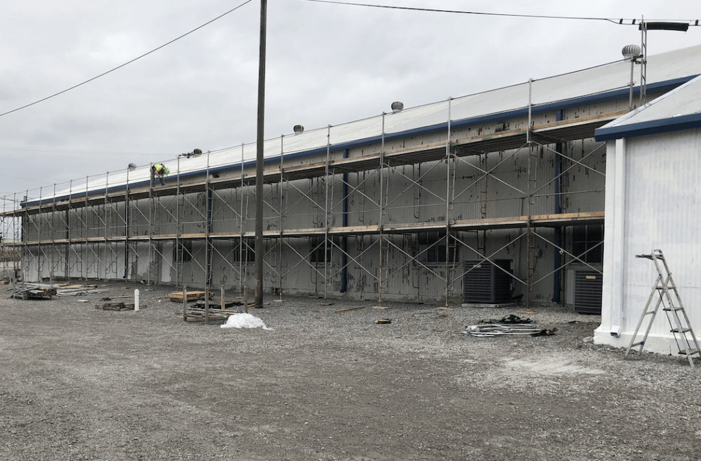 A large building is being built with scaffolding around it.