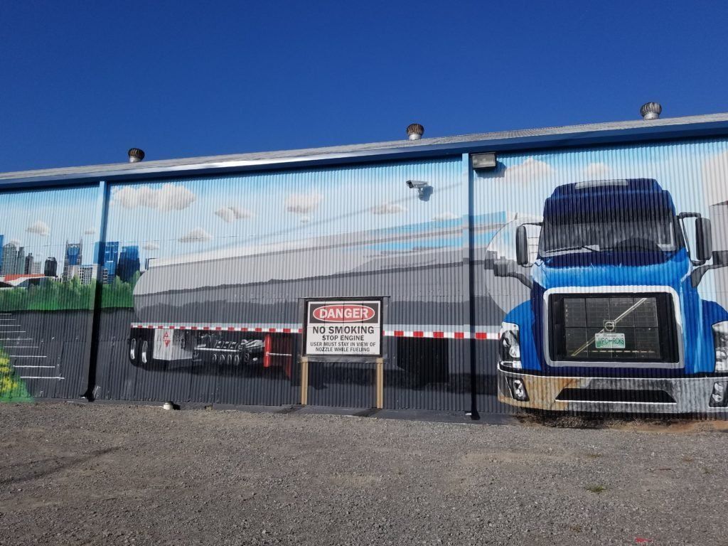 A truck is painted on the side of a building