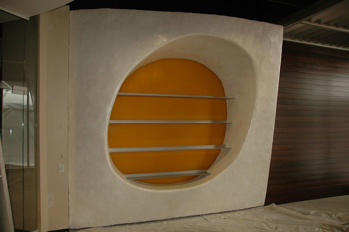 A white wall with a yellow circle in the middle