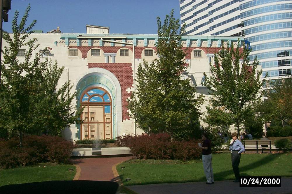 A man standing in front of a building with the date 10/14/2000
