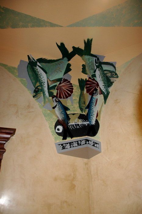 A painting of fish on a wall with the word fish on it