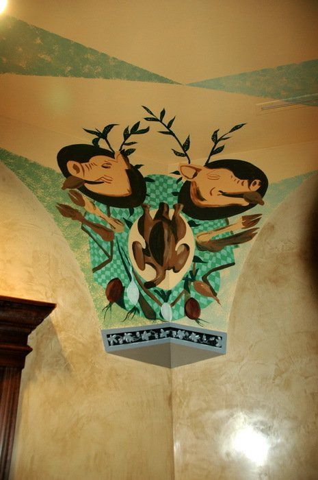A wall with a painting of two deer on it