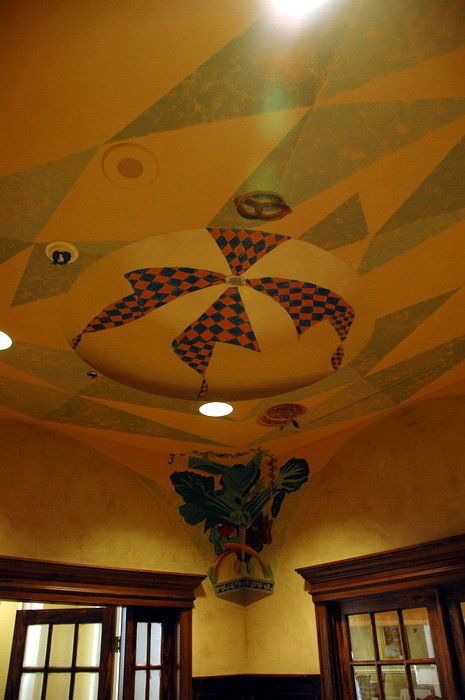 A room with a ceiling that has a painting on it