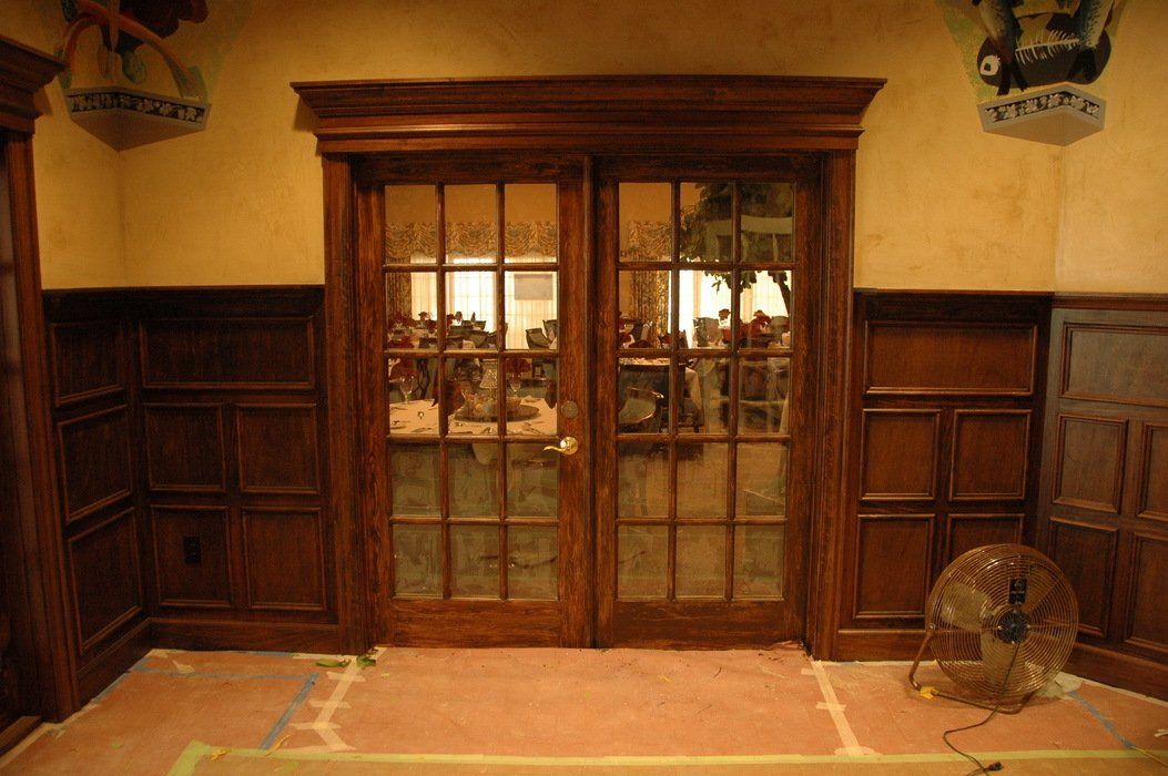 A room with sliding glass doors and a fan on the floor