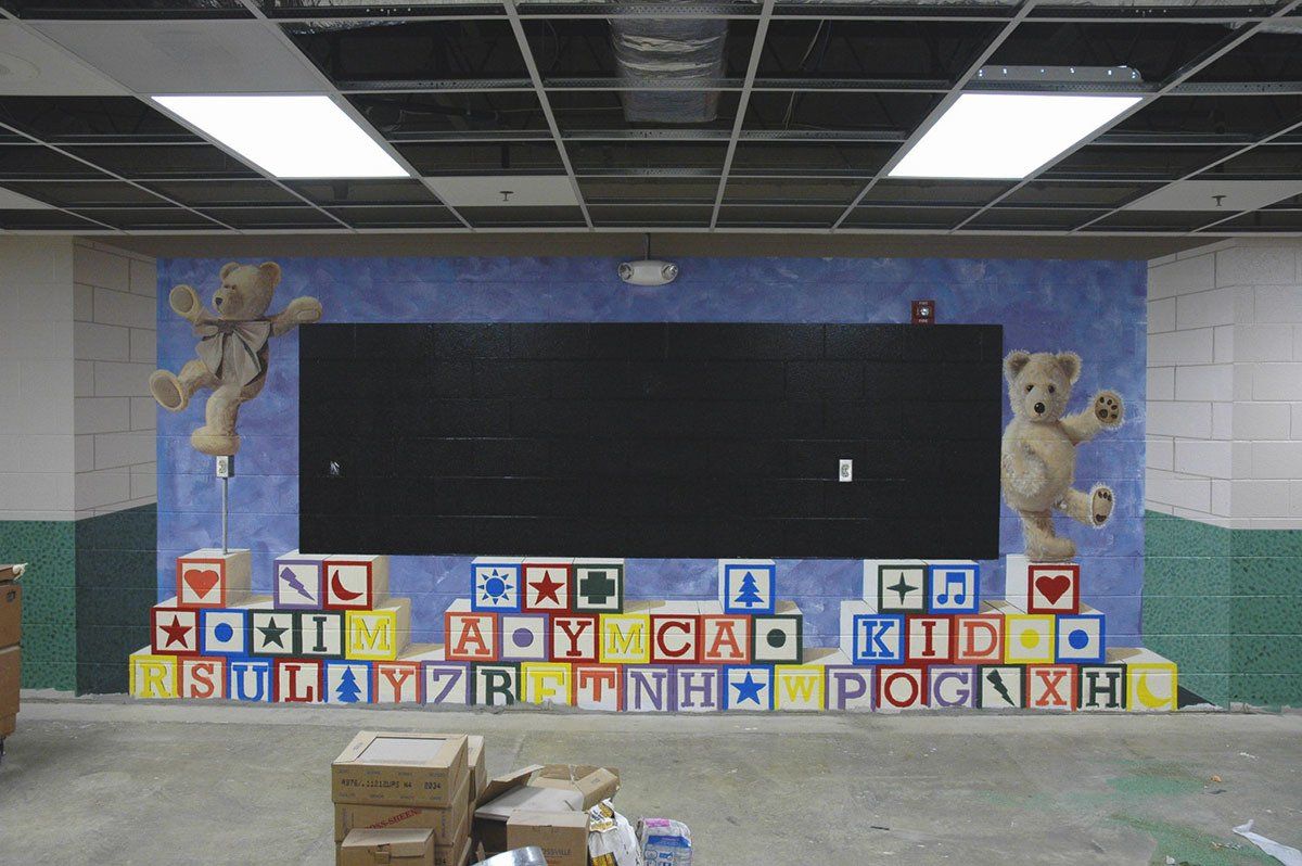 A room with a blackboard and alphabet blocks on the wall