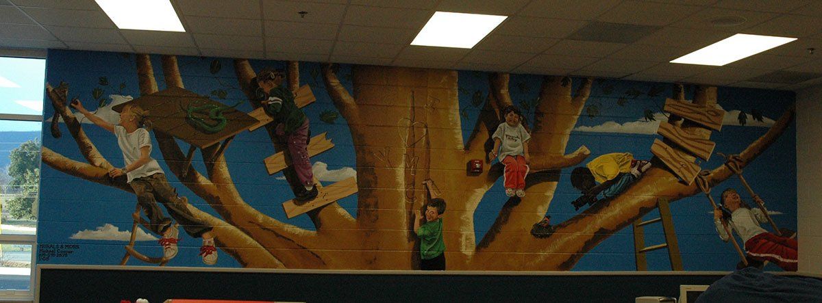 A mural of children climbing a tree in a room