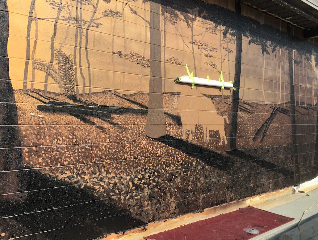 A wall with a picture of trees on it