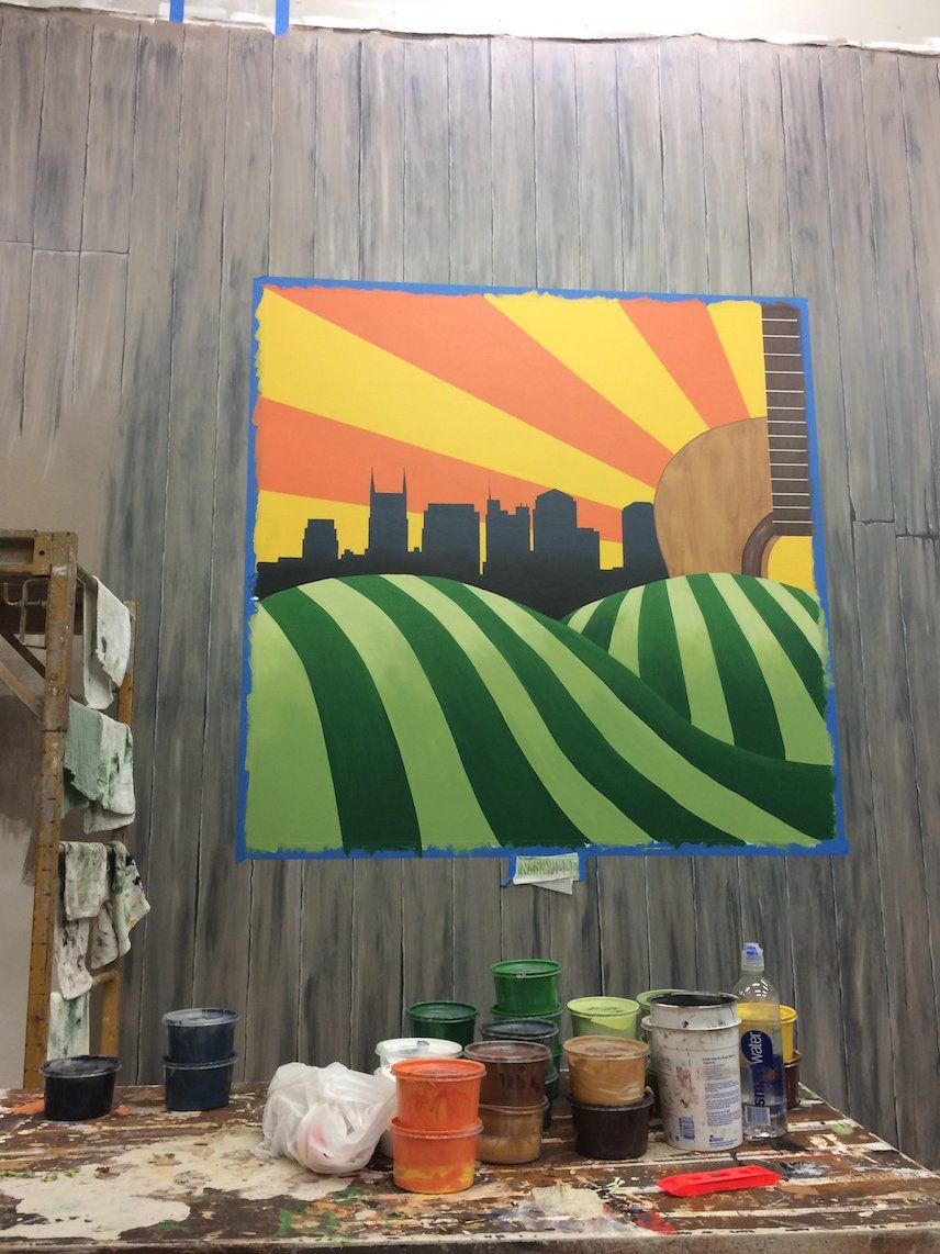 A painting on a wall with a city in the background