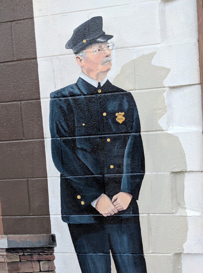 A painting of a police officer on a wall