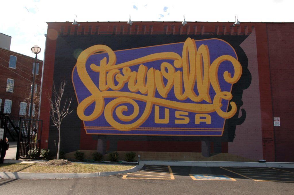 A large mural on the side of a building says storyville usa