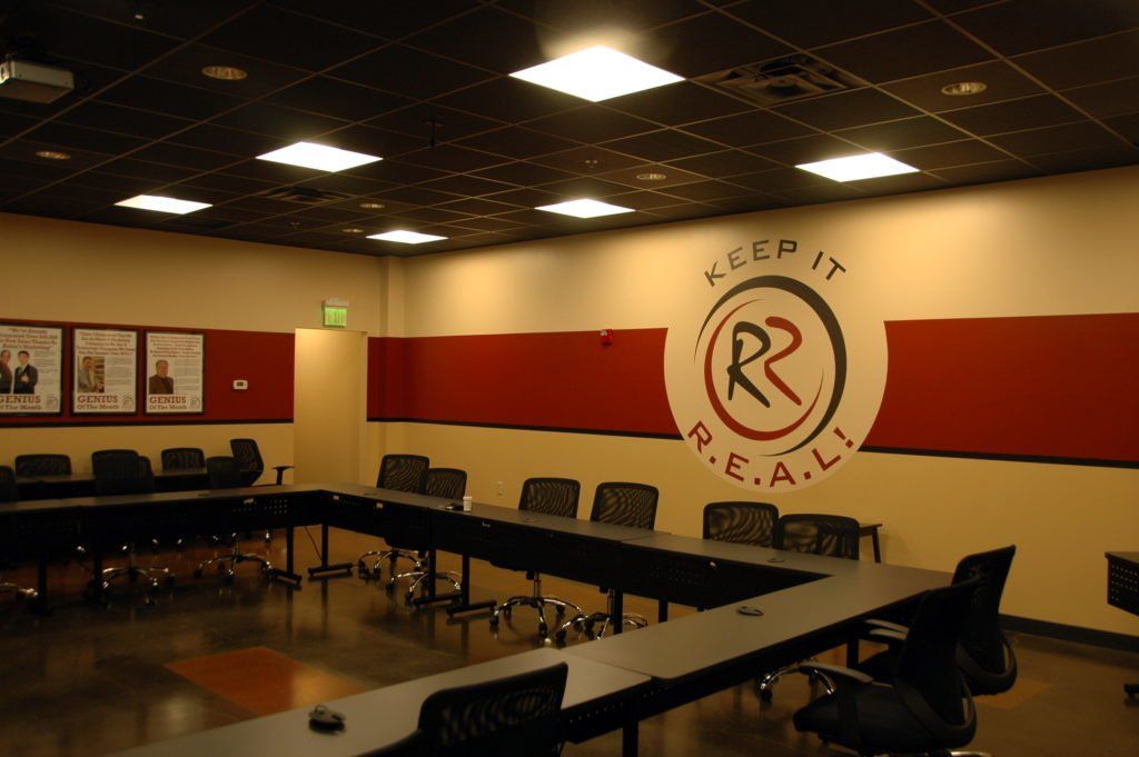 A conference room with a sign that says keep it real