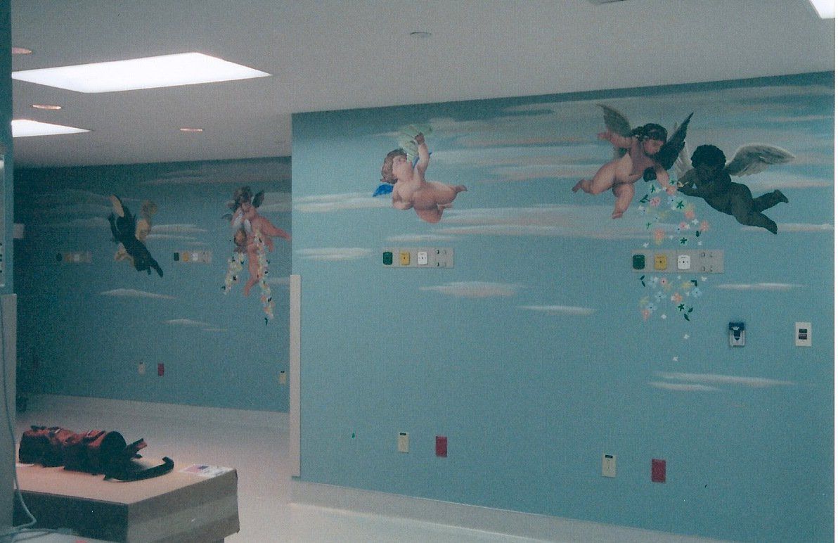 A room with a painting of cherubs on the wall