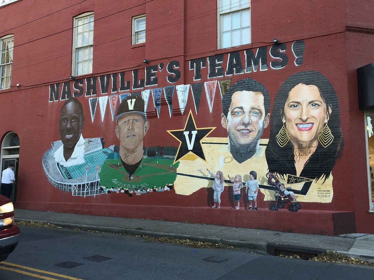 A mural on the side of a building that says nashville 's teams